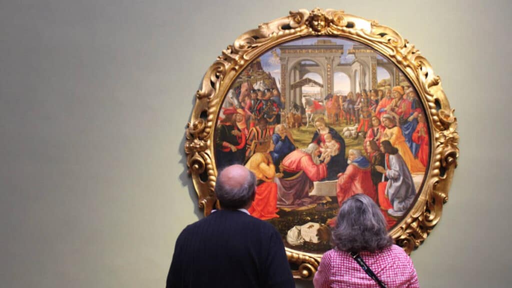 An old man with his wife admiring an art in Uffizi Gallery