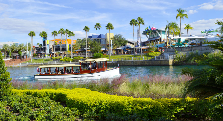 View of a small ferry boat on the lake and the CityWalk across the lake