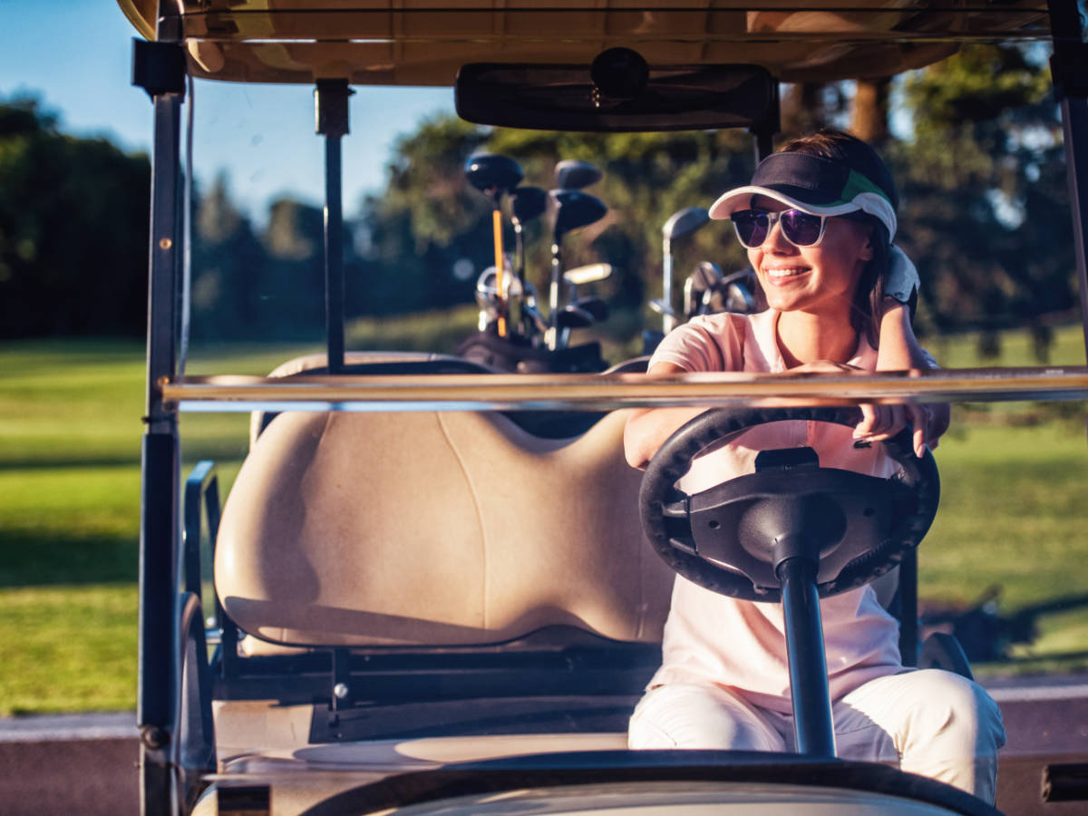 A woman on a golf cart at the University of Denver Golf Club at Highlands Ranch