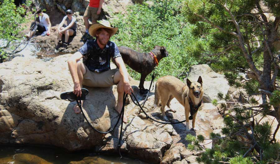 The author's husband with their dogs at the Upper Fish Creek Falls