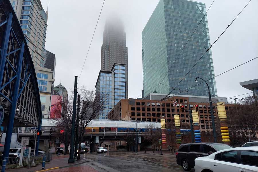 View of buildings and the street in Uptown Charlotte during a rainy day