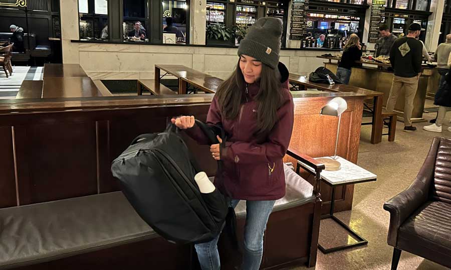 Abigail getting ready to carry her Tortuga Travel Backpack