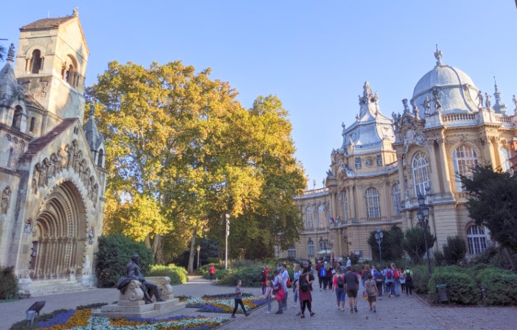 People walking on the grounds in front of Vajdahunyad Castle