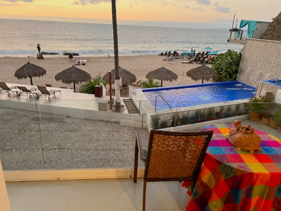 View of the pool and the ocean with the colorful sky in Vallarta Shores