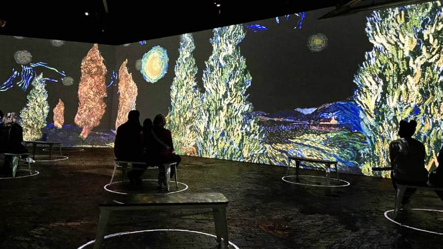 View of people watching the Van Gogh Immersive Exhibit at Camp North End