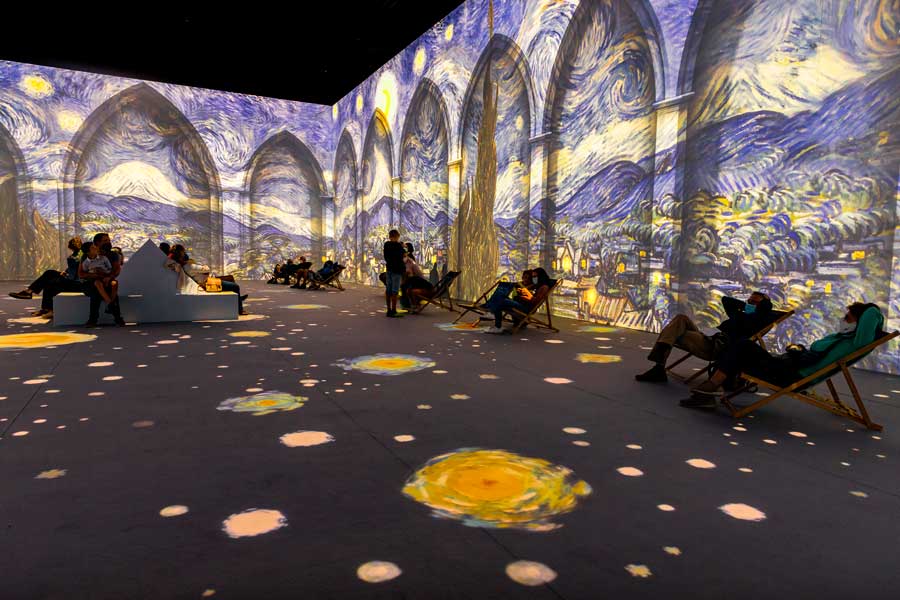 People wandering inside the Van Gogh Immersive Experience