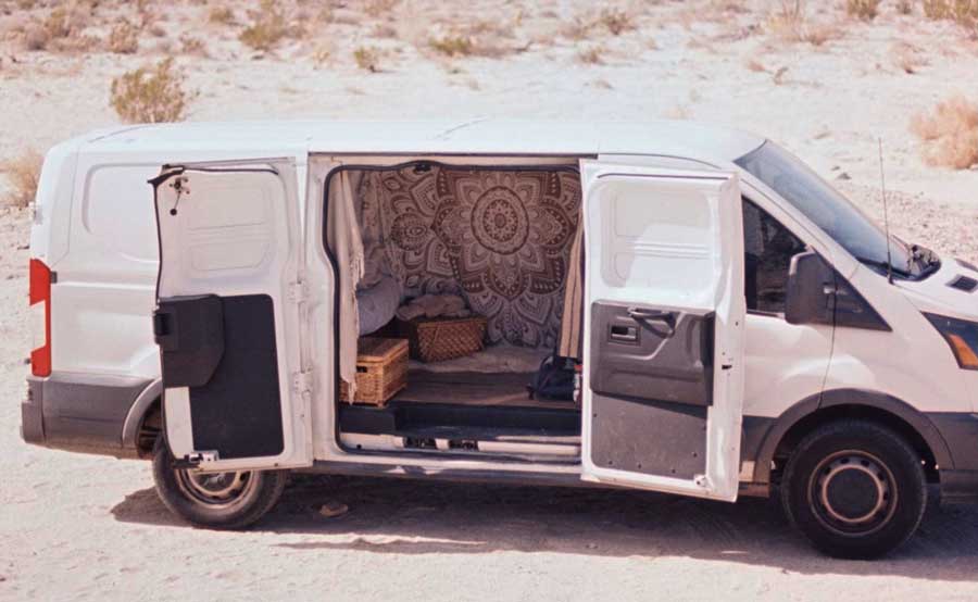 The author's friend road-tripping van on a desert