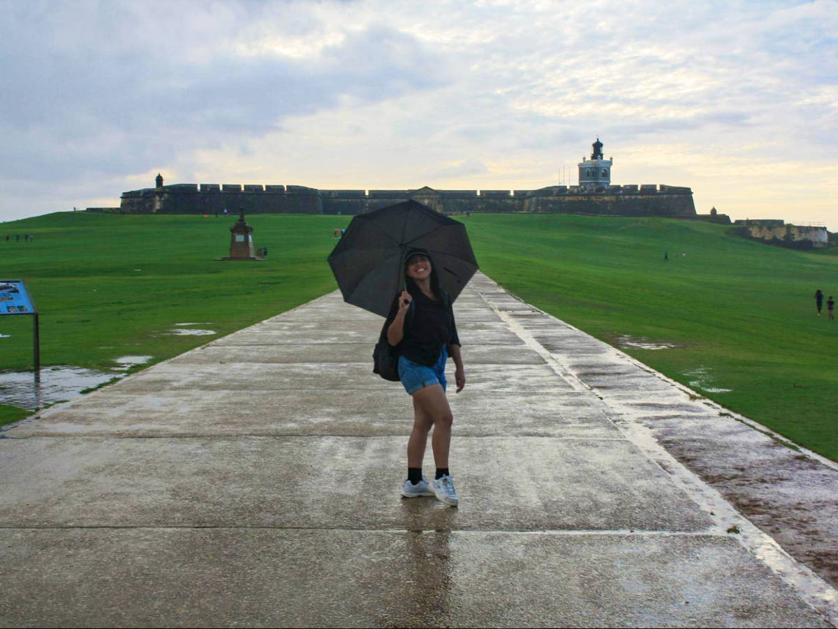 The author Vanessa Ramos, holding an umbrella on a rainy day