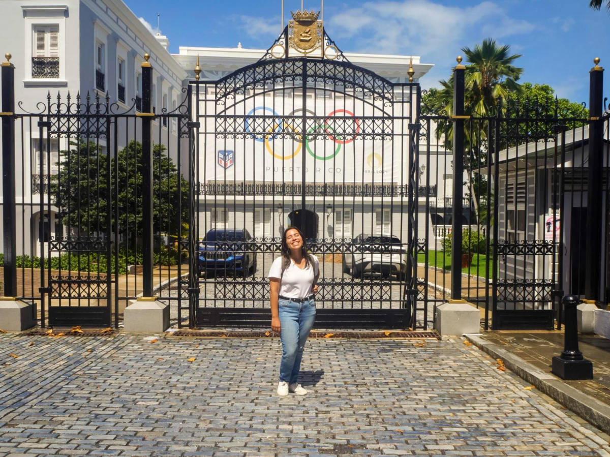 The author Vanessa Ramos posing for a photo in front of the La Fortaleza