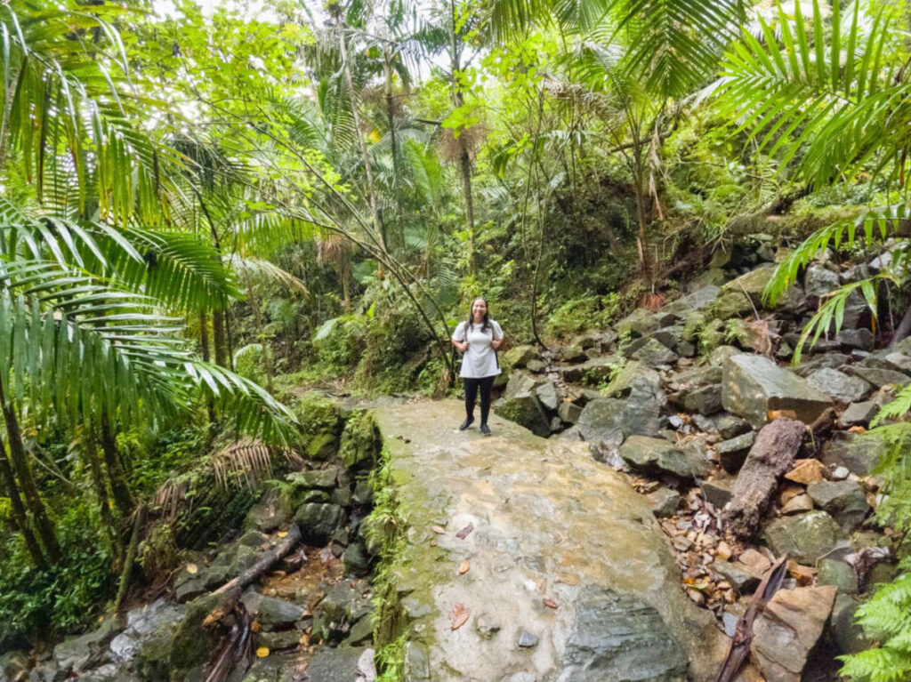 The author Vanessa Ramos smiling for a photo during a hike in El Yunque