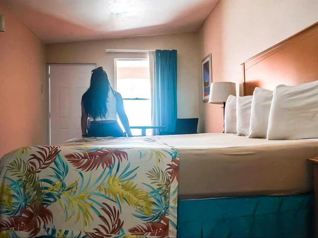 The author Vanessa Ramos, sitting on the bed in Parador MaunaCaribe