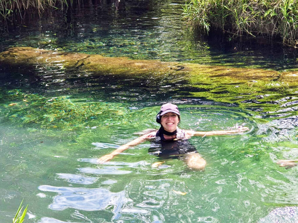 The author Vanessa Ramos, swimming on a hidden water spring in Arecibo