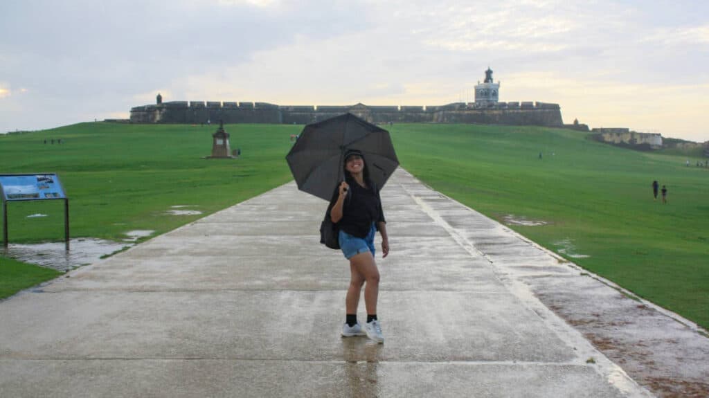 The author. Vanessa Ramos holding an umbrella after a rain in Castillo San Felipe del Morro