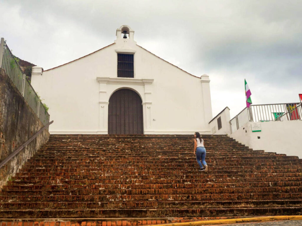 The author Vanessa Ramos, climbing up the stairs to Porta Coeli Church in San German