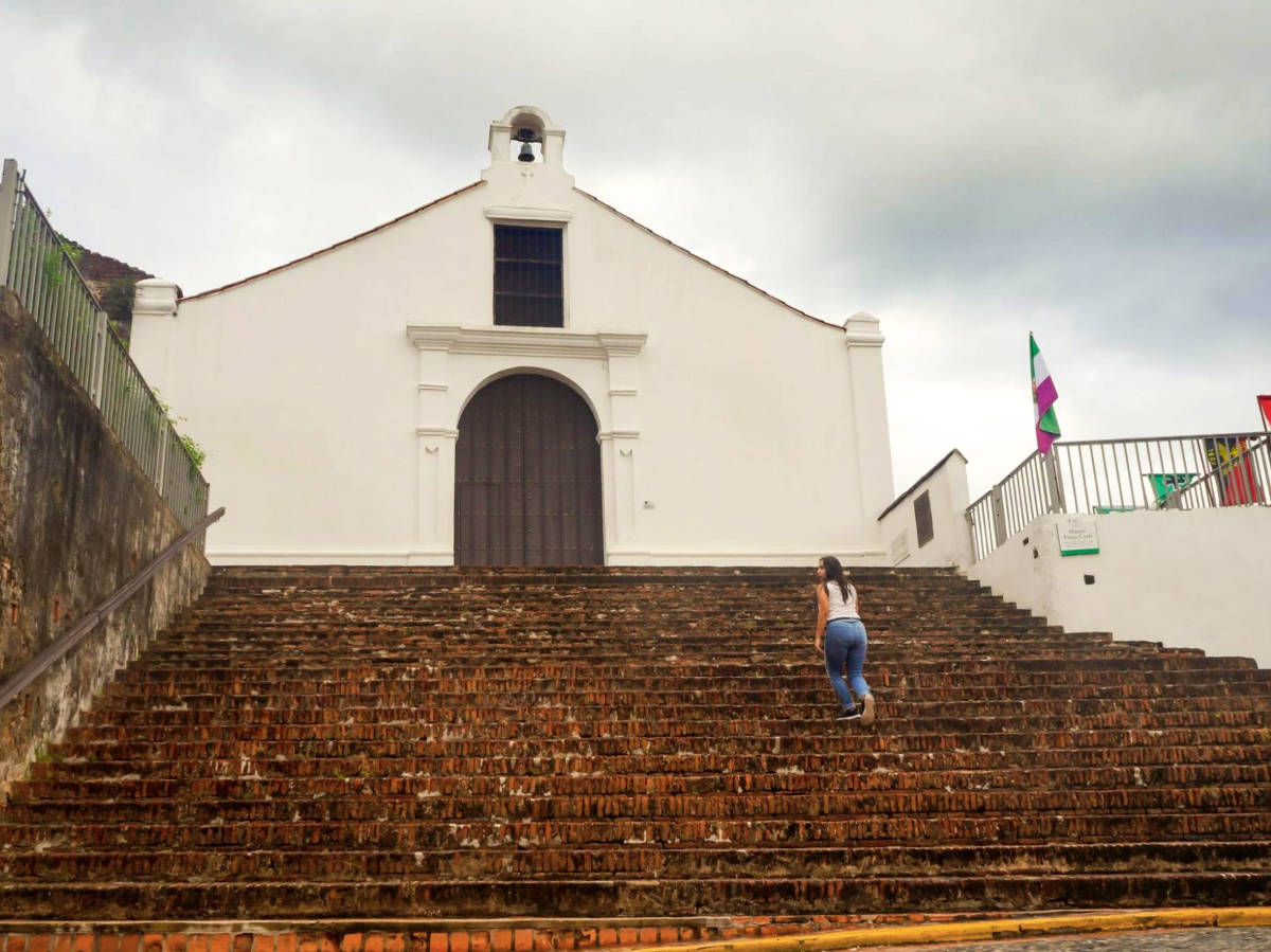 The author Vanessa Ramos, climbing up the stairs to Porta Coeli Church in San German