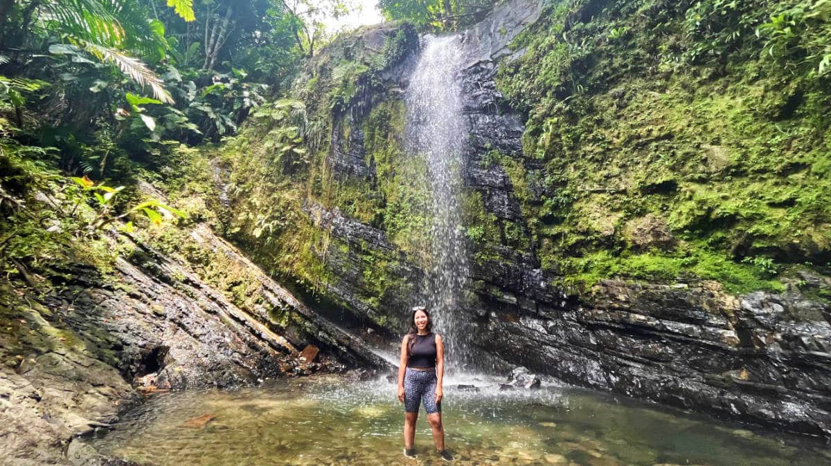 The author, Vanessa Ramos and a waterfall at the El Yunque National Rainforest