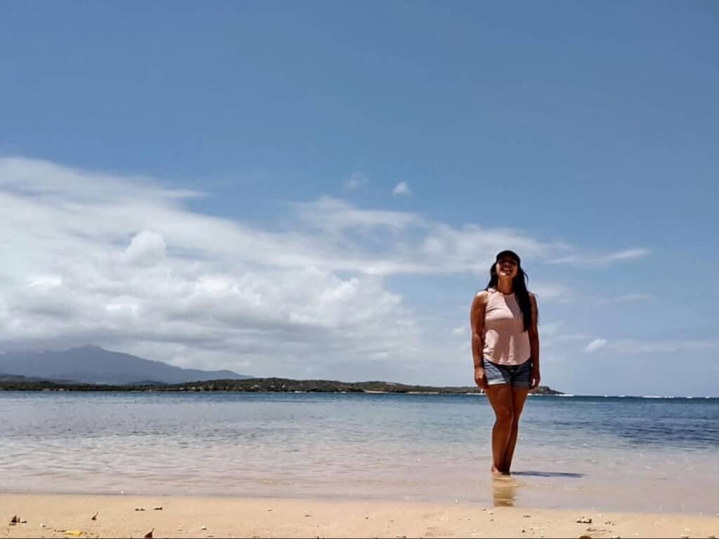 The author, Vanessa Ramos posing for a photo on the Seven Seas Beach