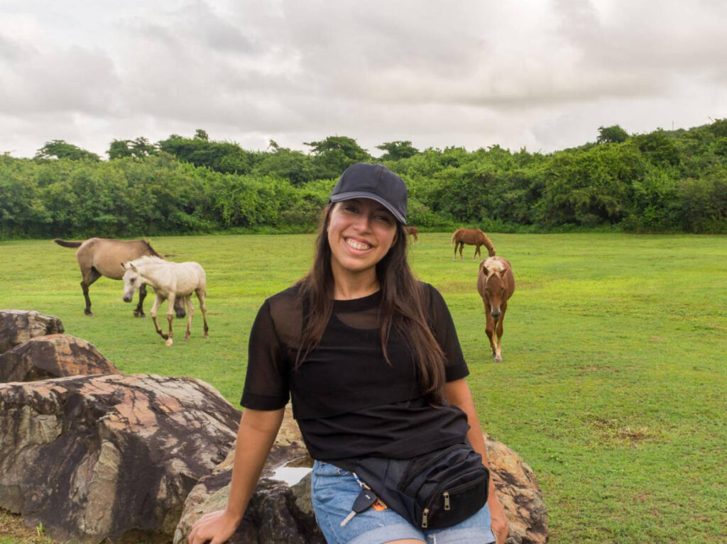 The author Vanessa Ramos with wild horses on her background