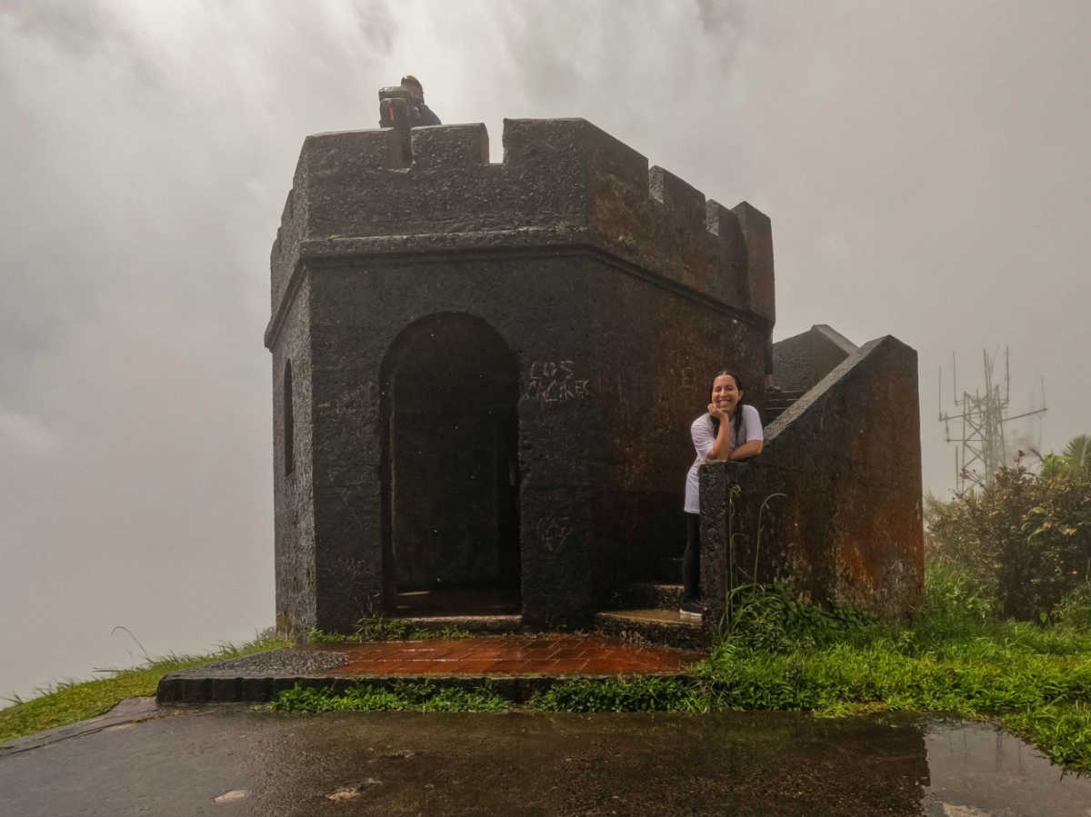 The author Vanessa Ramos posing for a photo at the El Yunque Peak on a Rainy Day