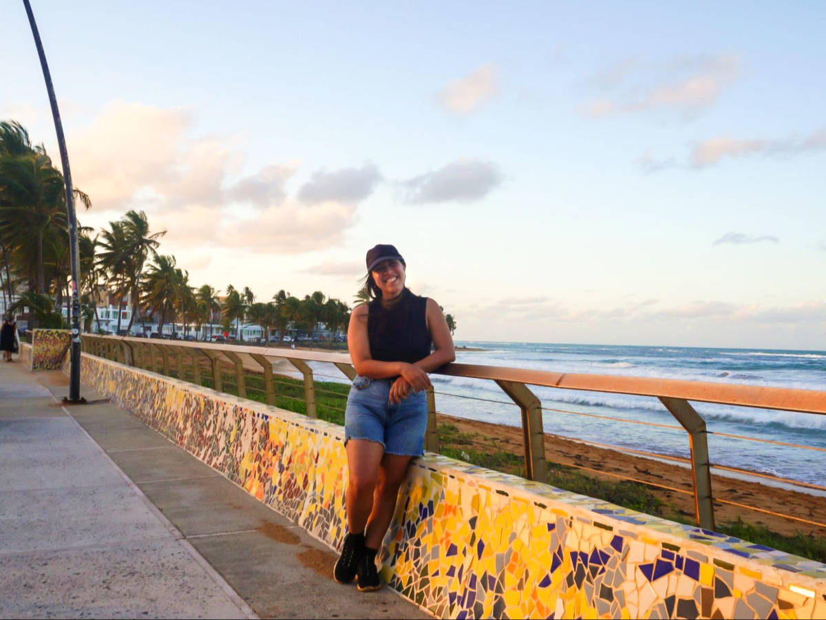 The author Vanessa Ramos, posing near the railings at La Pared in Luquillo