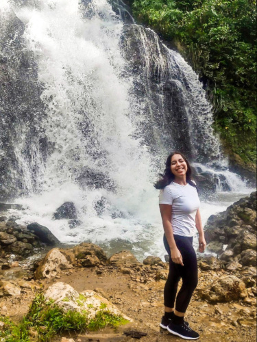 The author Vanessa Ramos, posing in front of the La Planta waterfalls