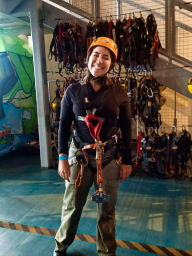 The author Vanessa Ramos, wearing helmet, holding rope, geared up at T-Mobile District