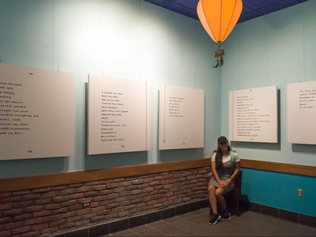 The author Vanessa Ramos sitting at the back gallery in the Poet’s Passage