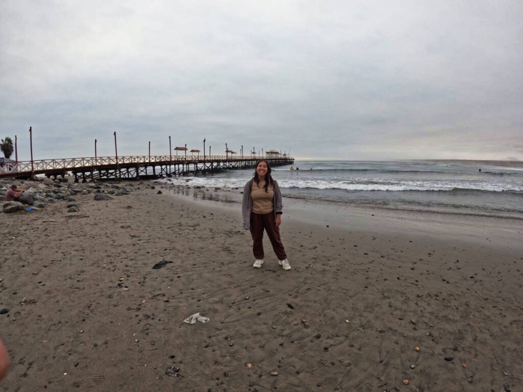 The author Vanessa at the beach on a gloomy day