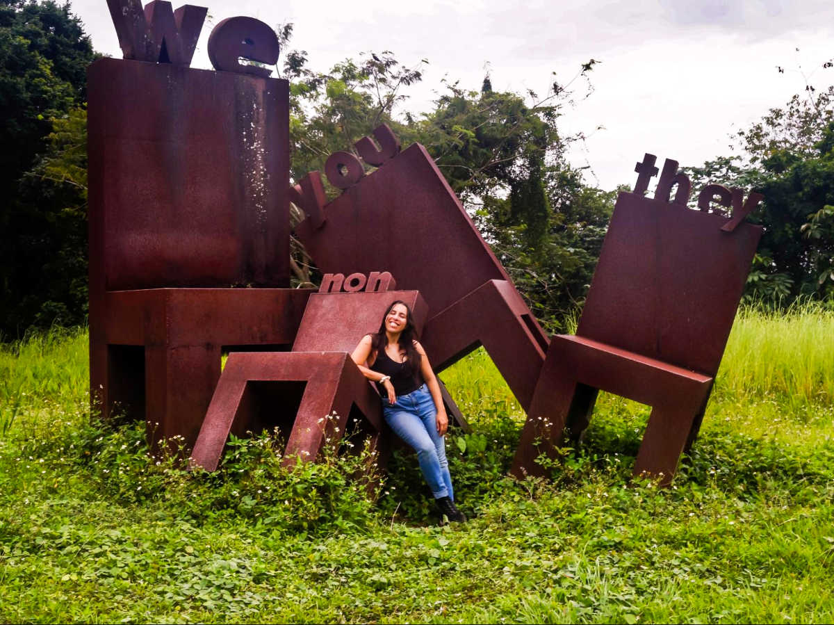 The author Vanessa Ramos, standing next to the art installation in Botanical Garden of Rio Piedras