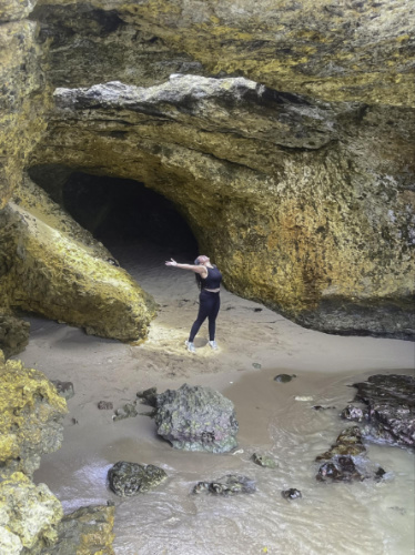 The author Vanessa Ramos posing in front of the cave entrance in Cabo Rojo Beach