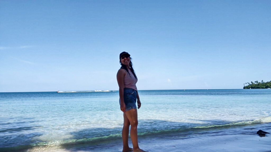 The author, Vanessa Ramos, posing under the shade at the shoreline of Buyé Beach