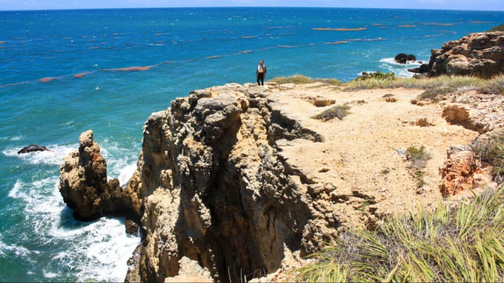The author, Vanessa Ramos posing near the cliff in the oceanfront Cabo Rojo’s Wildlife Refuge