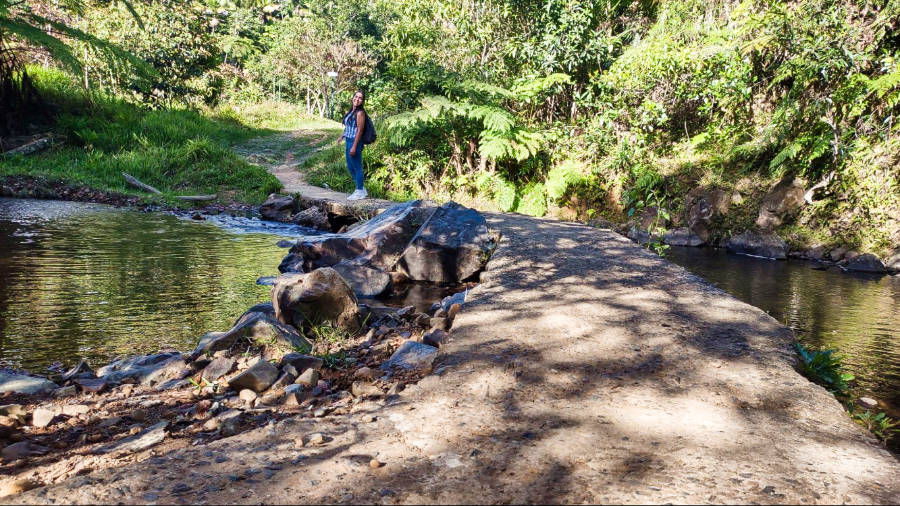 The author Vanessa, posing near the river in Charco Azul trail