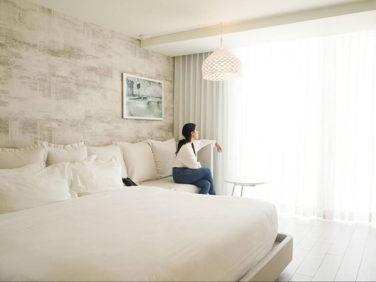 The author Vanessa Ramos sitting inside the hotel room in Condado Ocean Club Hotel