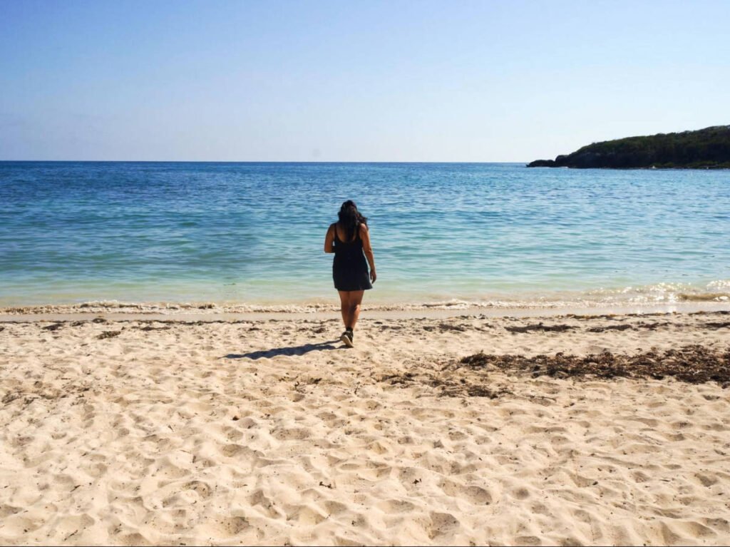 The author Vanessa Ramos, walking on the white sand Pata Prieta Beach