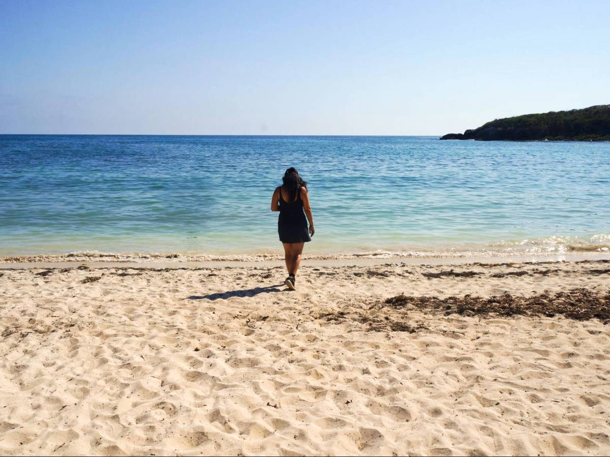 The author Vanessa Ramos, walking on the white sand Pata Prieta Beach