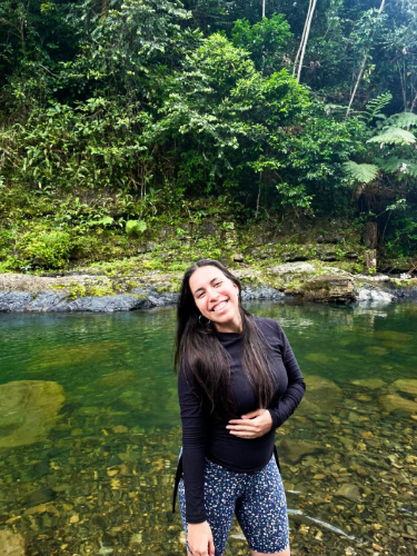 The author, Vanessa Ramos, posing with the clear water in the background in Puente Roto