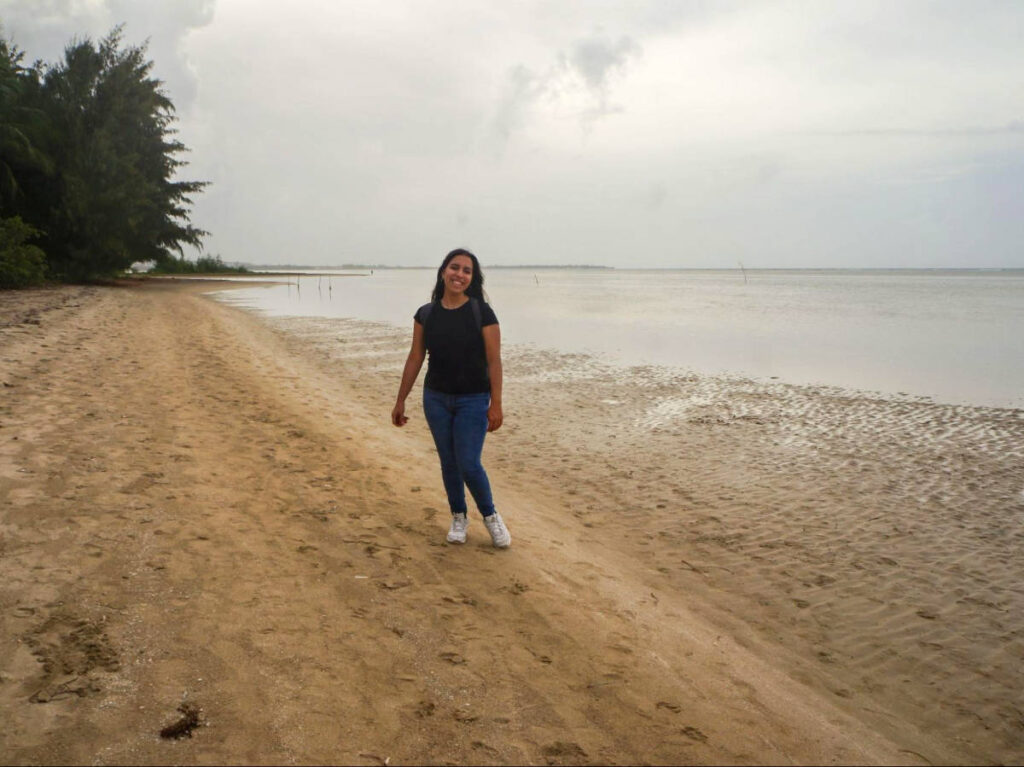 The author Vanessa smiling for a photo at the shoreline of Punta Bandera Beach