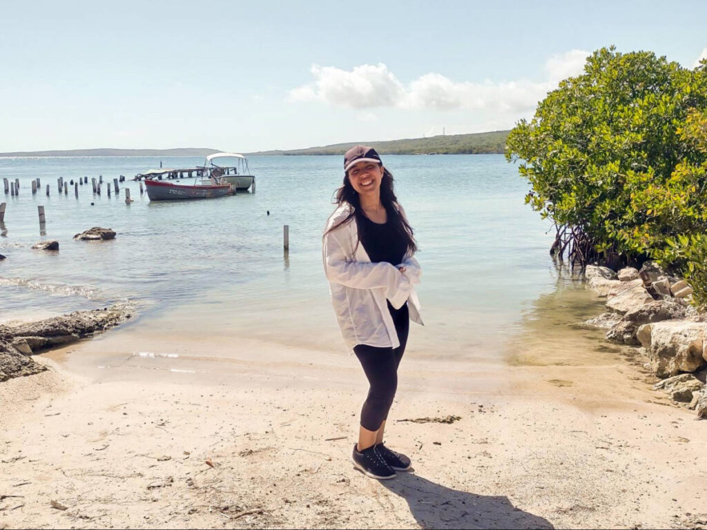 The author Vanessa Ramos, posing for a photo in front of the beach in San Jacinto