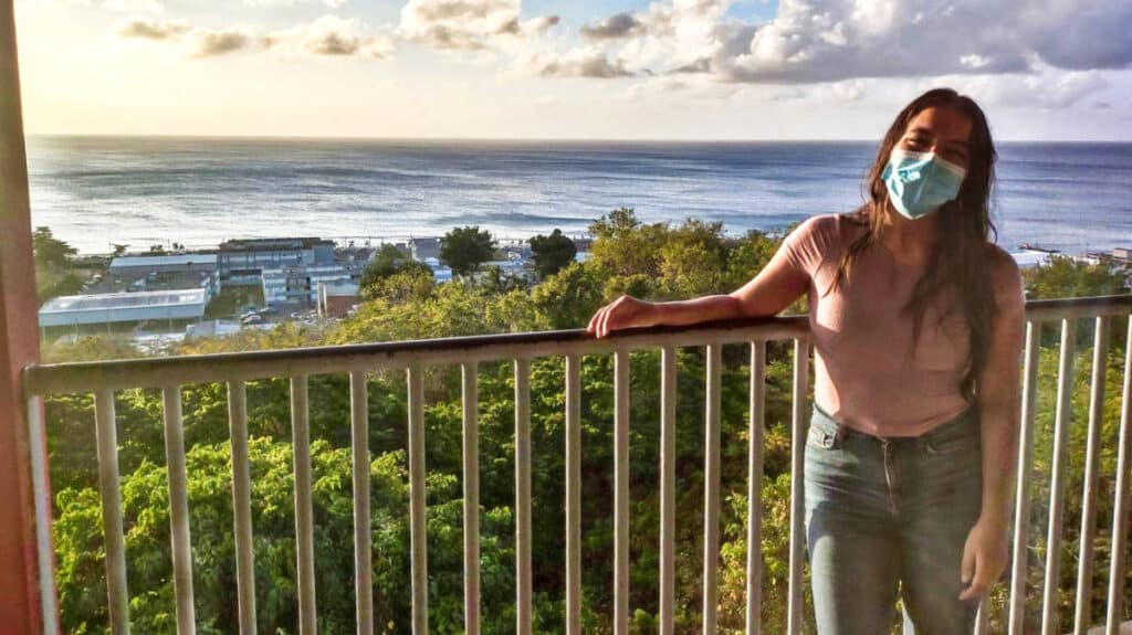 The author Vanessa Ramos posing on the balcony in el mirador in Aguadilla at sunset