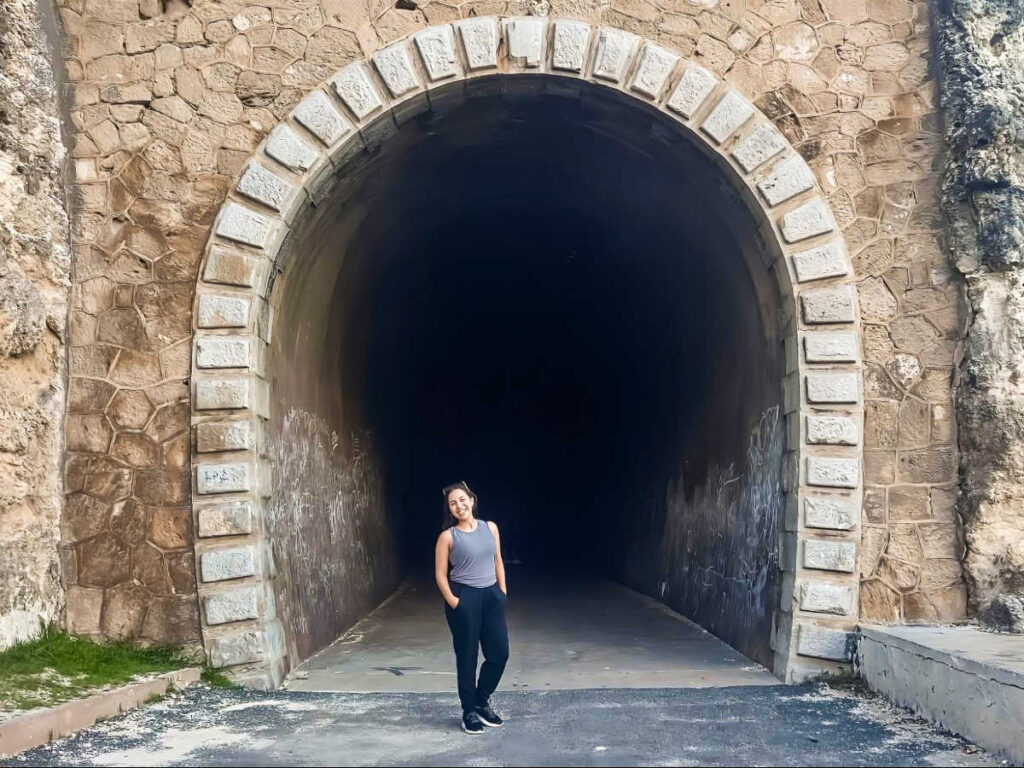 The author Vanessa Ramos, posing for a photo at the entrance of Guajataca Tunnel