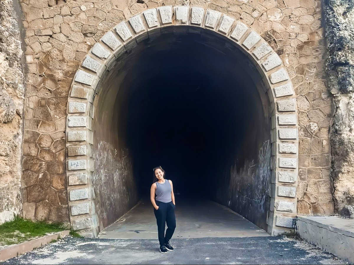 The author Vanessa Ramos, posing for a photo at the entrance of Guajataca Tunnel