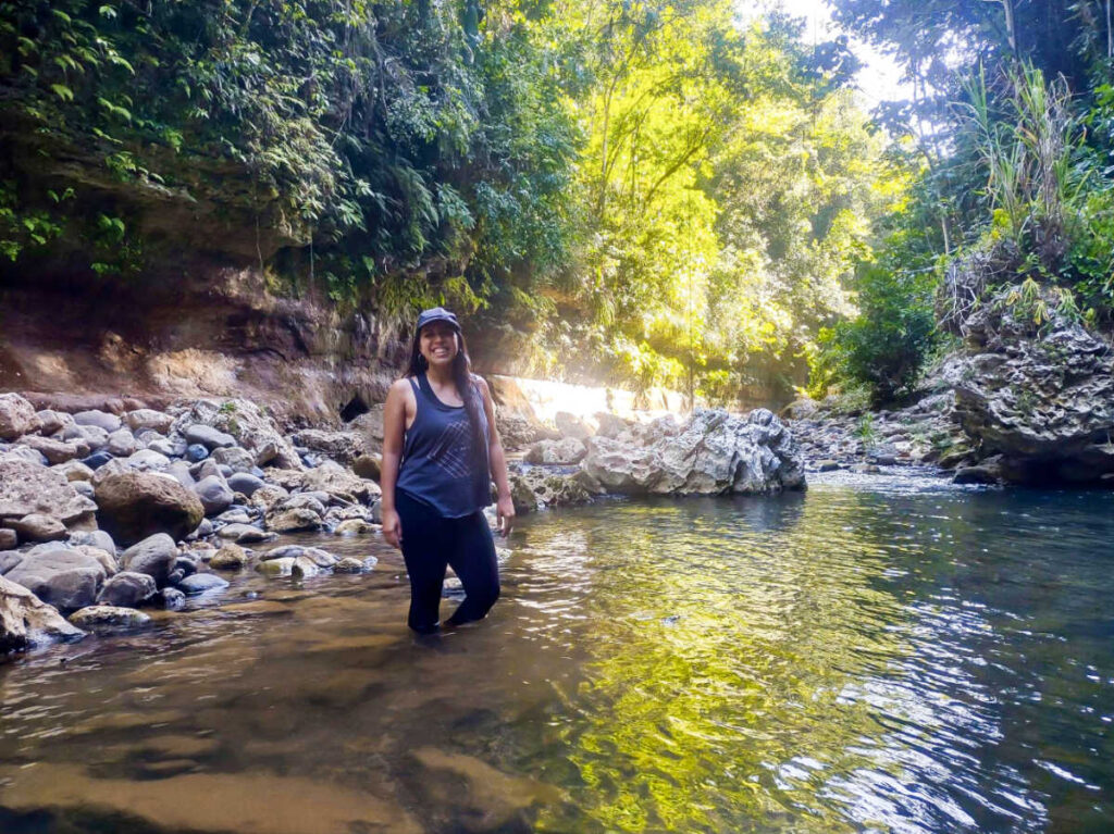 The author Vanessa Ramos, posing for a photo on the water in Tanamá Canyon