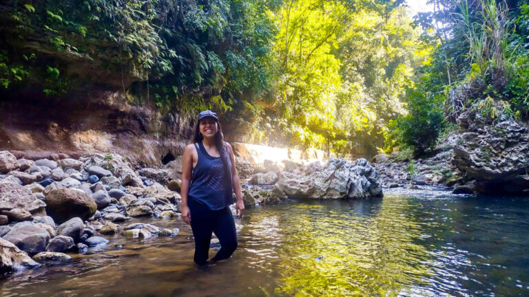The author Vanessa Ramos, posing for a photo on the river in Utuado