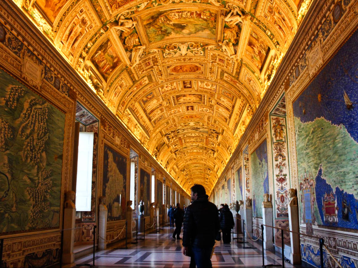 The people exploring the historic artifacts and stunning artwork inside the Vatican Museum