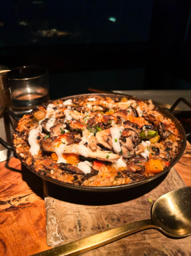 A huge pan of vegan paella made with mushrooms