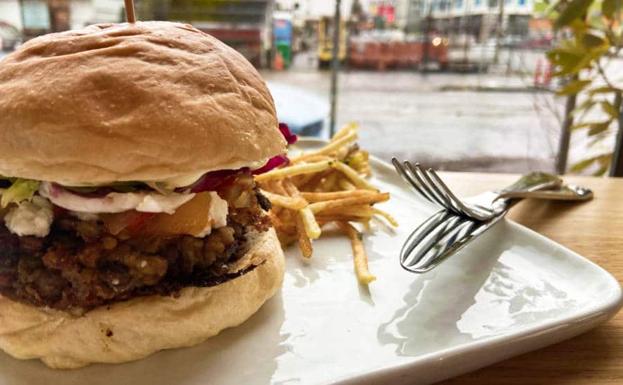 Closeup view of the veggie burger with fries on the side at Eastern Portland restaurant