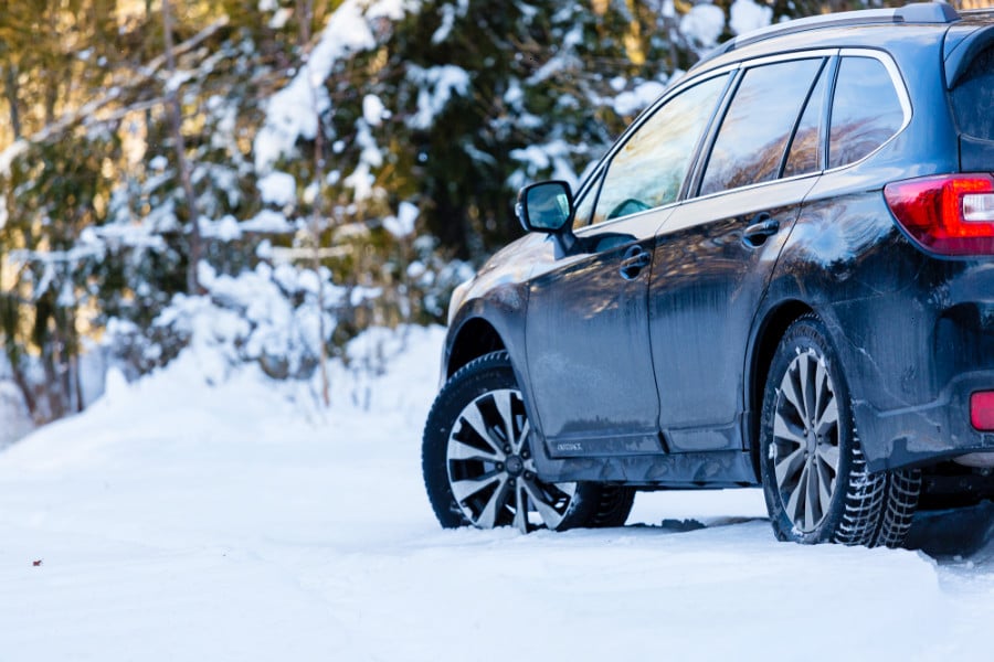 A car on a snowy forest road in Colorado