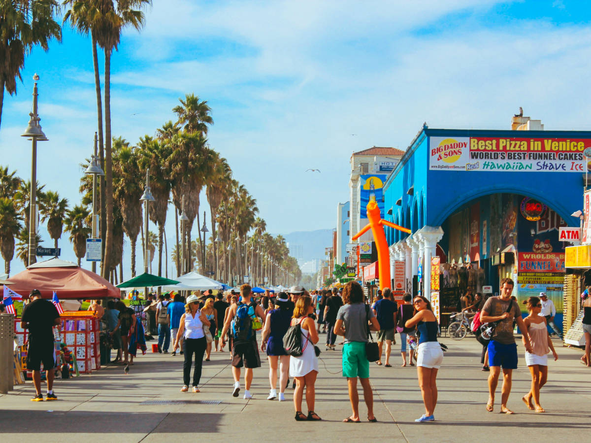 People walking along the Venice beach path walk area in Los Angeles