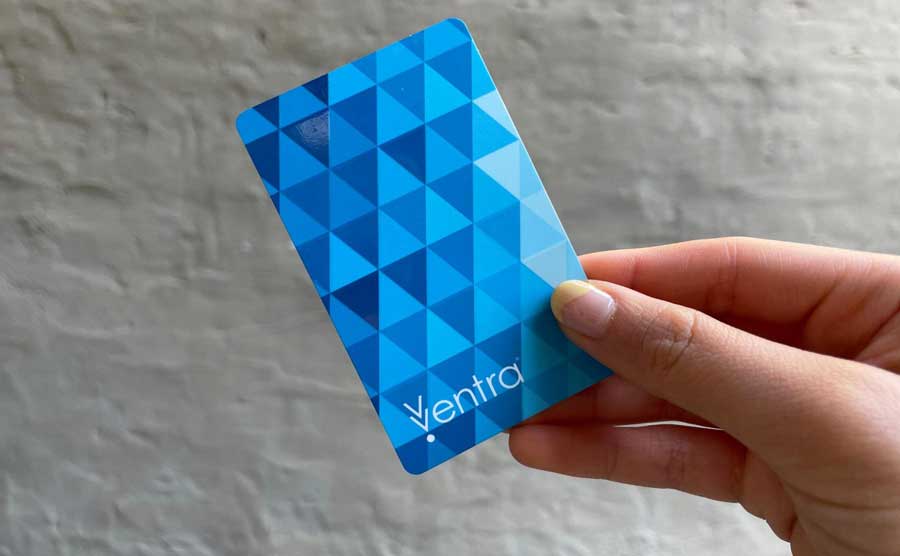 A hand holding a Ventra card